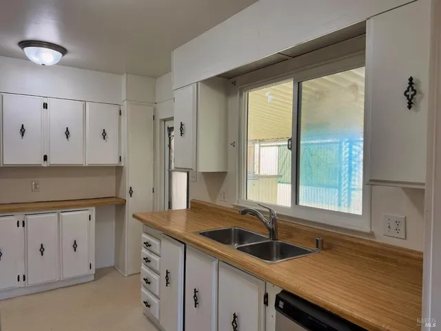 a kitchen with granite countertop a sink and a window
