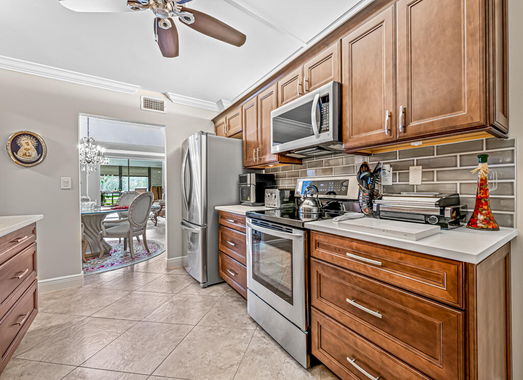 a kitchen with stainless steel appliances granite countertop a refrigerator a stove top oven a sink and dishwasher