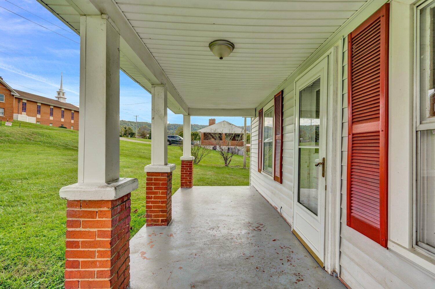 3191 Webster Road Blue Ridge, VA 24064 - Photo 4 of 18 a porch with a table and chairs next to yard