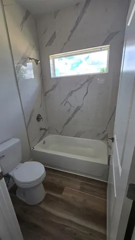 a bathroom with a toilet and a bathtub