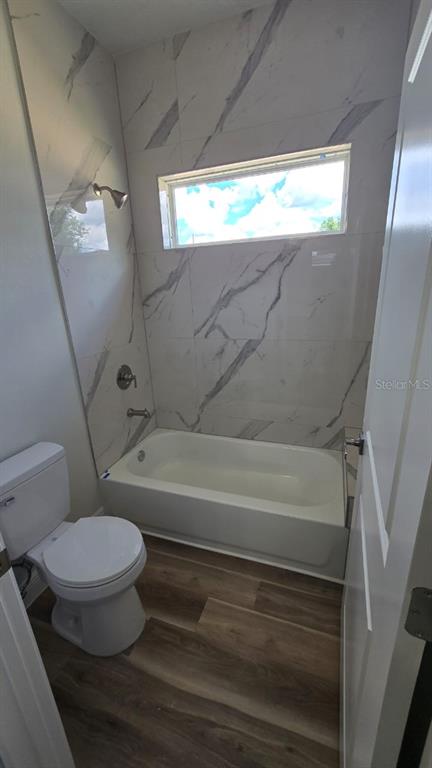 Undisclosed Address Orlando, FL 32805 - Photo 7 of 16 a bathroom with a toilet and a bathtub