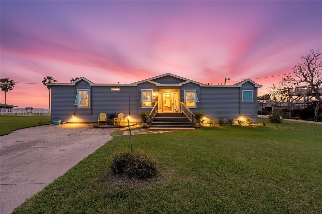 a backyard of a house with table and chairs