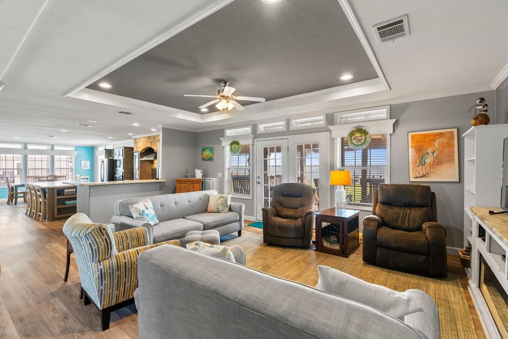 159 Copano Ridge Road Rockport, TX 78382 - Photo 11 of 31 a living room with furniture ceiling fan and a rug