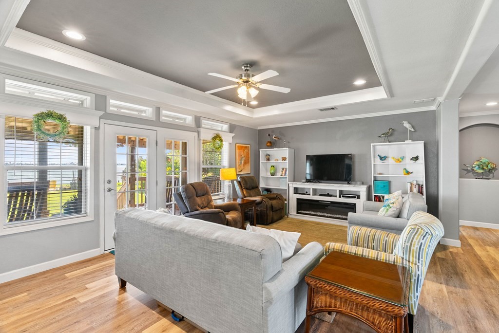 159 Copano Ridge Road Rockport, TX 78382 - Photo 12 of 31 a living room with furniture a flat screen tv and a fireplace