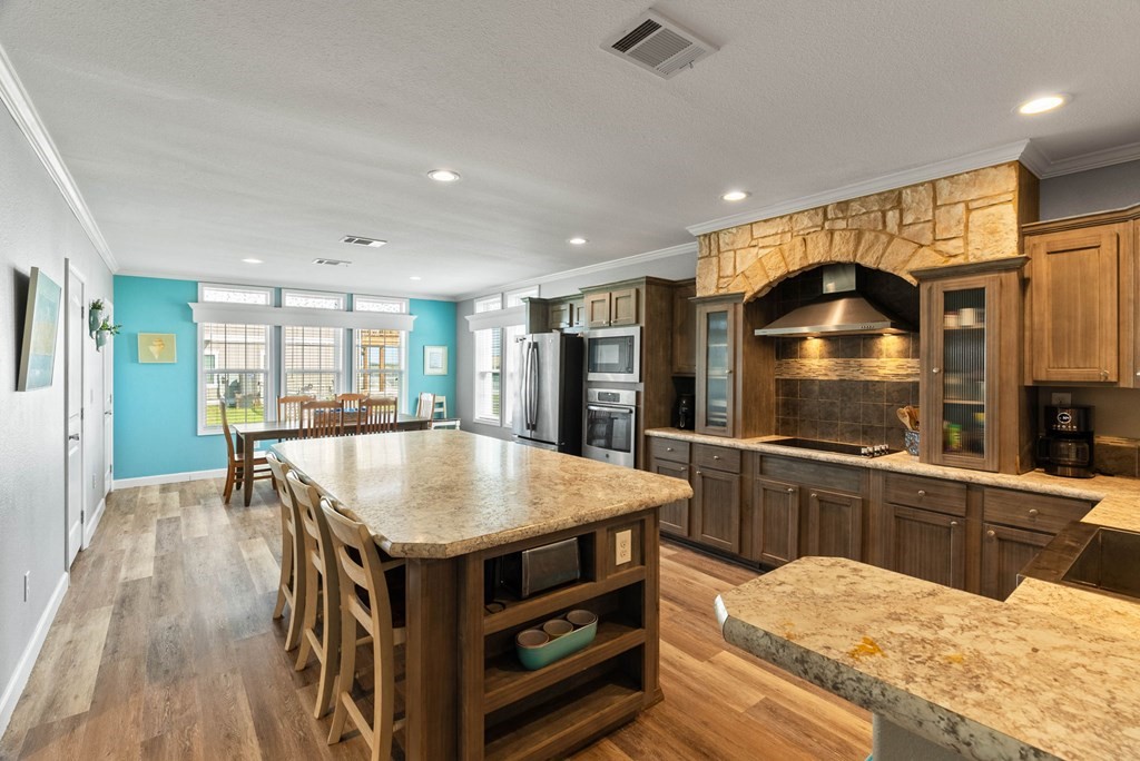 159 Copano Ridge Road Rockport, TX 78382 - Photo 15 of 31 a kitchen with stainless steel appliances granite countertop a stove and a refrigerator