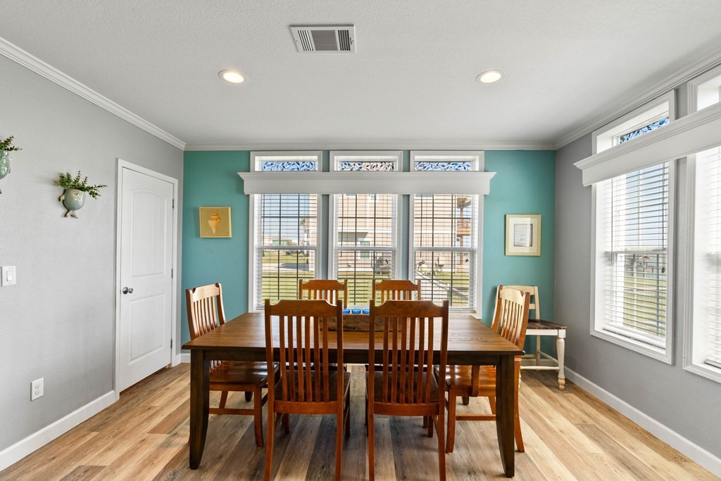 159 Copano Ridge Road Rockport, TX 78382 - Photo 16 of 31 a view of a dining room with furniture window and wooden floor