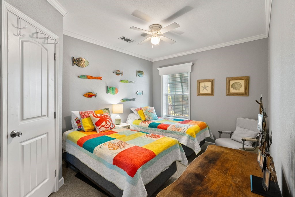 159 Copano Ridge Road Rockport, TX 78382 - Photo 22 of 31 a bedroom with a bed and a table in it