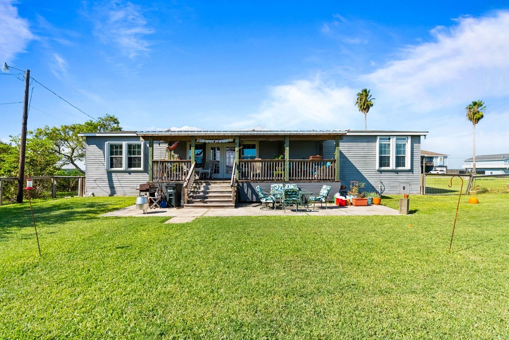 159 Copano Ridge Road Rockport, TX 78382 - Photo 25 of 31 a view of a house with backyard porch and sitting area