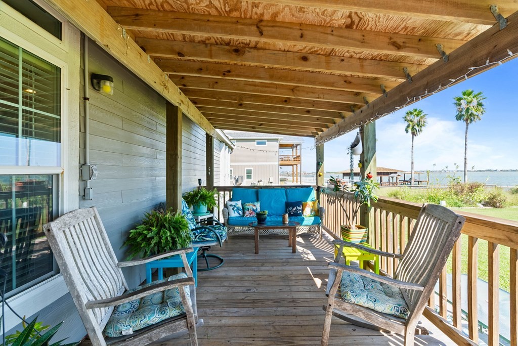 159 Copano Ridge Road Rockport, TX 78382 - Photo 9 of 31 a view of a chair and tables in the patio