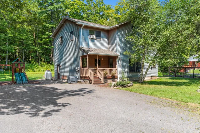 a view of backyard with a table and chairs and potted plants