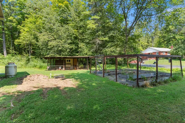 a view of a house with backyard and a slide
