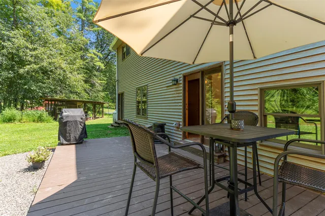 a view of a wooden deck next to a yard