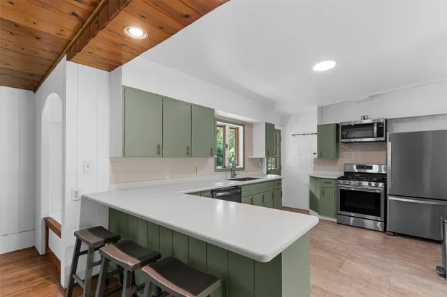 a kitchen with sink cabinets and wooden floor