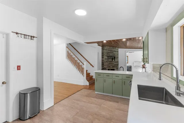 a kitchen with refrigerator and sink