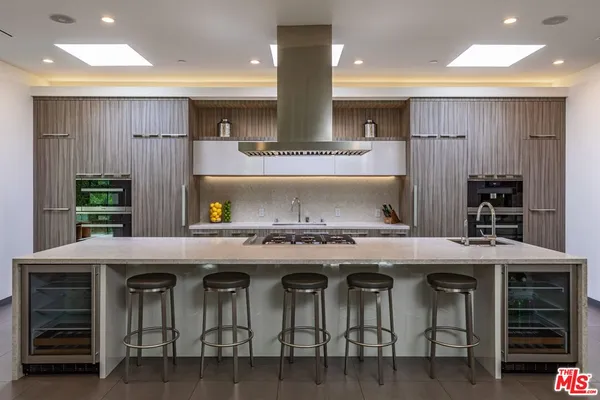 a kitchen with stainless steel appliances granite countertop a stove and cabinets