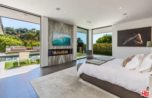a bedroom with a large bed and a large window