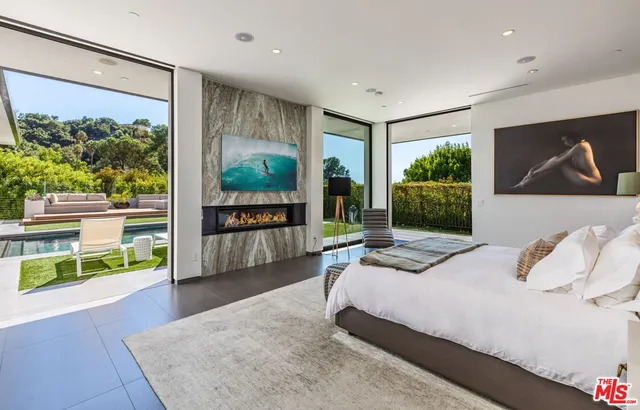 a bedroom with a large bed and a large window