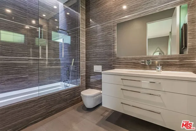 a bathroom with a sink mirror toilet and bathtub