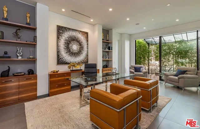 a work room with furniture and a large window
