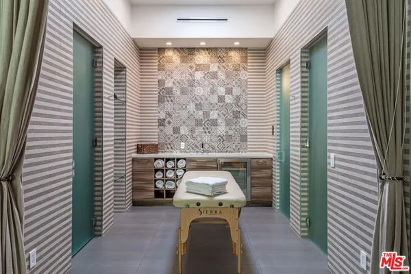 a view of a balcony with furniture and floor to ceiling window