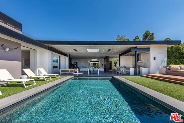 a view of swimming pool with outdoor seating