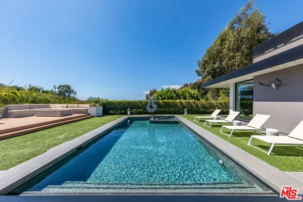 a view of swimming pool with lounge chair