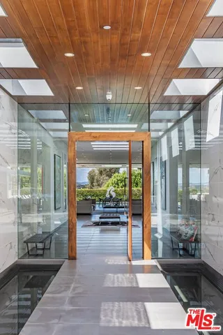 a lobby with furniture and floor to ceiling window