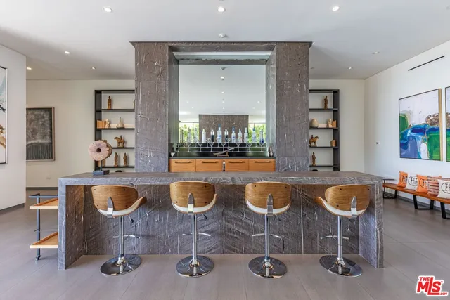 a dining room with wooden floor and large windows