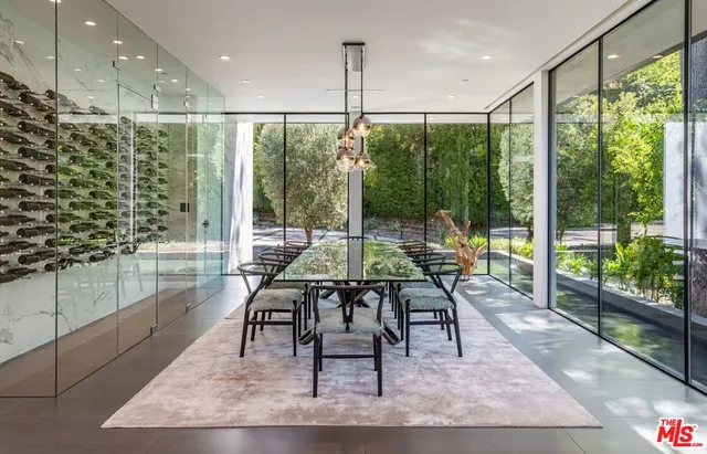 a living room with a floor to ceiling window and wooden floor