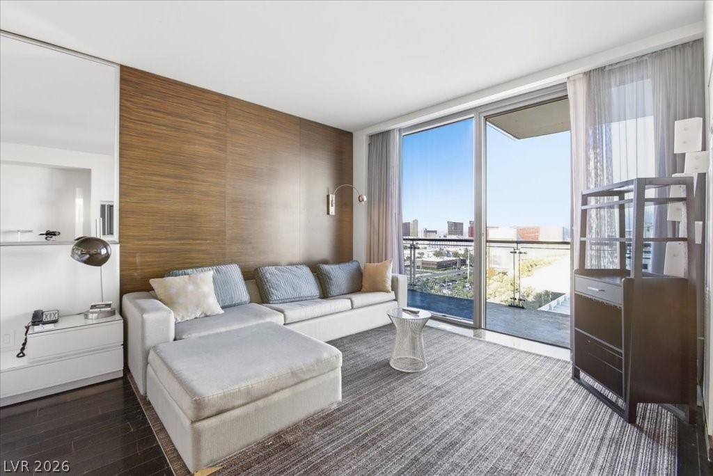 4381 West Flamingo Road, Unit 10306 Las Vegas, NV 89103 - Photo 9 of 26 This bright living space features large glass doors and sleek flooring.