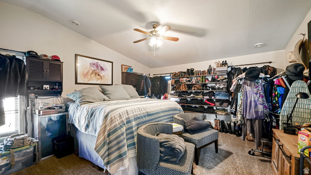 490 South Main Street Kamas, UT 84036 - Photo 8 of 25 Spacious room featuring vaulted ceilings, a ceiling fan with light, and carpet flooring