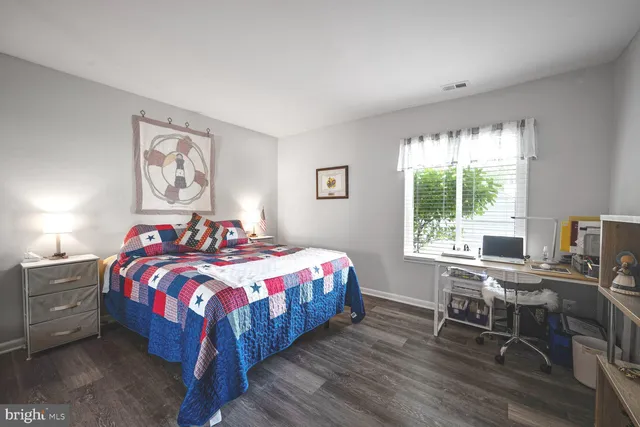 a bedroom with a bed table and a window