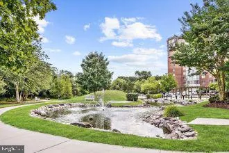 a view of a kitchen with kitchen island a sink and a large window