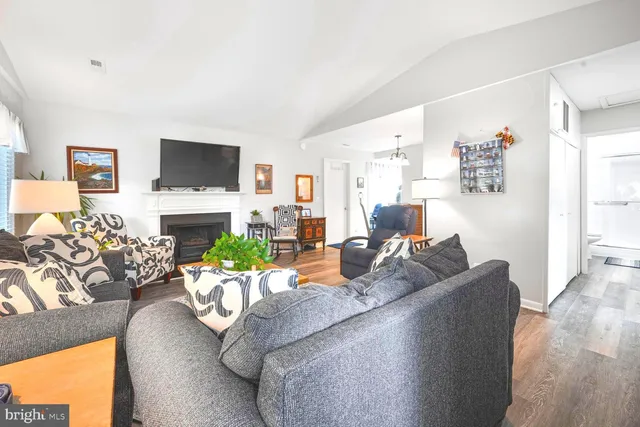 a living room with fireplace furniture and a flat screen tv