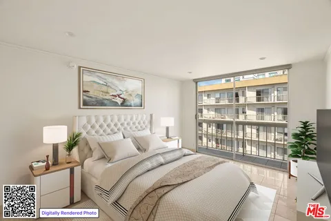 a bedroom with a bed a couch and a window