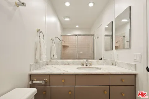 a bathroom with a sink double vanity and a mirror