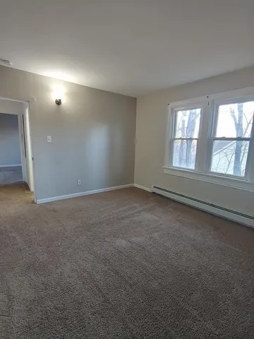 an empty room with an empty space and windows