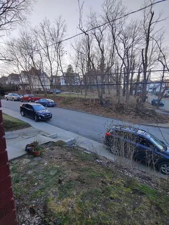 a backyard of a house with fire pit and trees