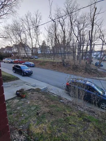 a backyard of a house with fire pit and trees