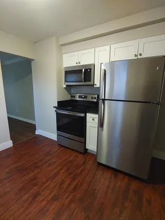 a kitchen with stainless steel appliances a refrigerator and a stove top oven