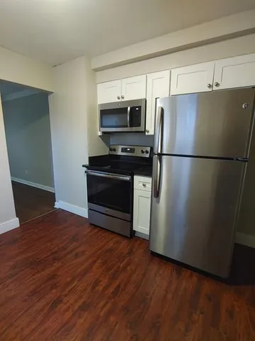 a kitchen with stainless steel appliances a refrigerator and a stove top oven
