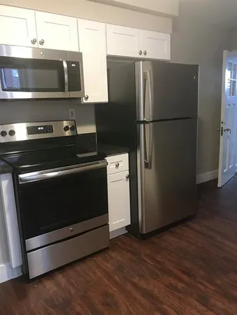 a kitchen with stainless steel appliances and wooden cabinets