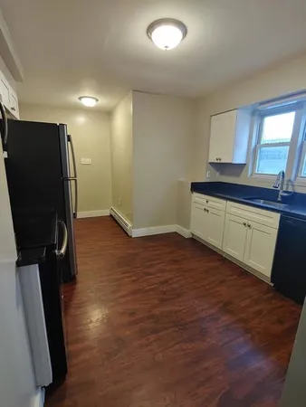 a room with lots of wooden furniture and a window
