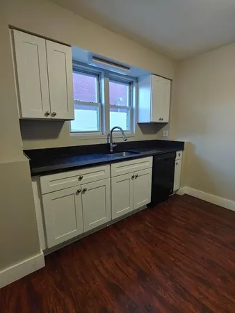 a kitchen with sink and cabinets