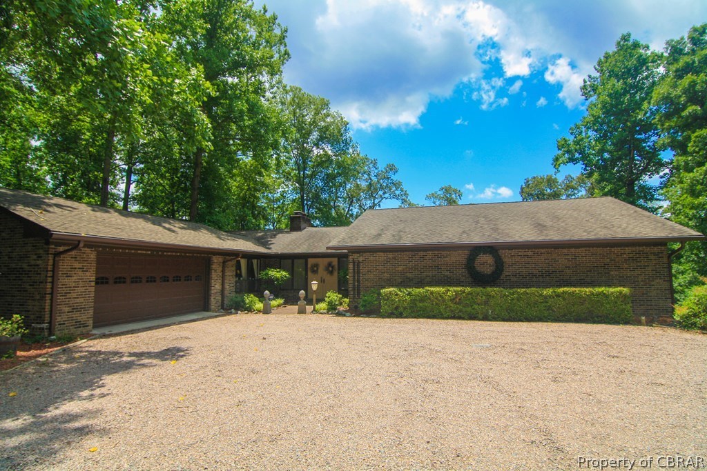 1472 Laurel Point Road Lancaster, VA 22503 - Photo 6 of 40 a front view of a house with a yard and garage
