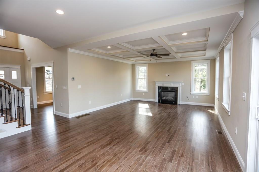 120 Pulpit Road Bedford, NH 03110 - Photo 26 of 40 an empty room with wooden floor fireplace and windows