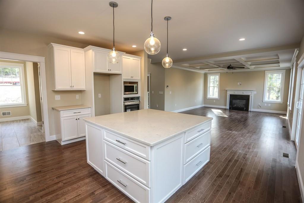 120 Pulpit Road Bedford, NH 03110 - Photo 28 of 40 a open kitchen with white cabinets and wooden floor