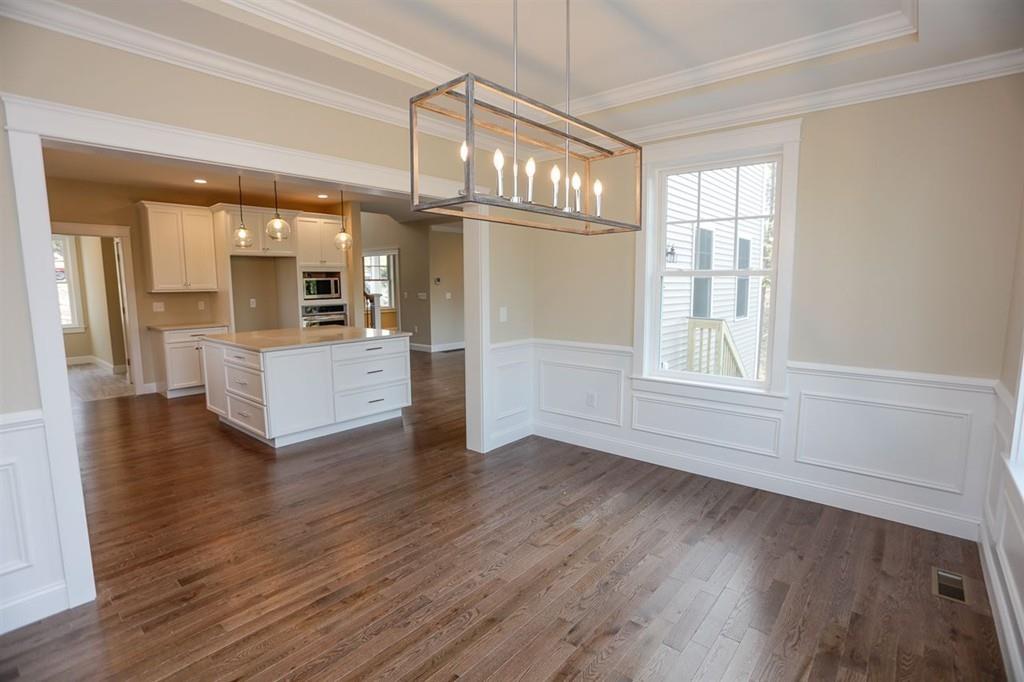120 Pulpit Road Bedford, NH 03110 - Photo 29 of 40 a view of a livingroom with a kitchen and wooden floor