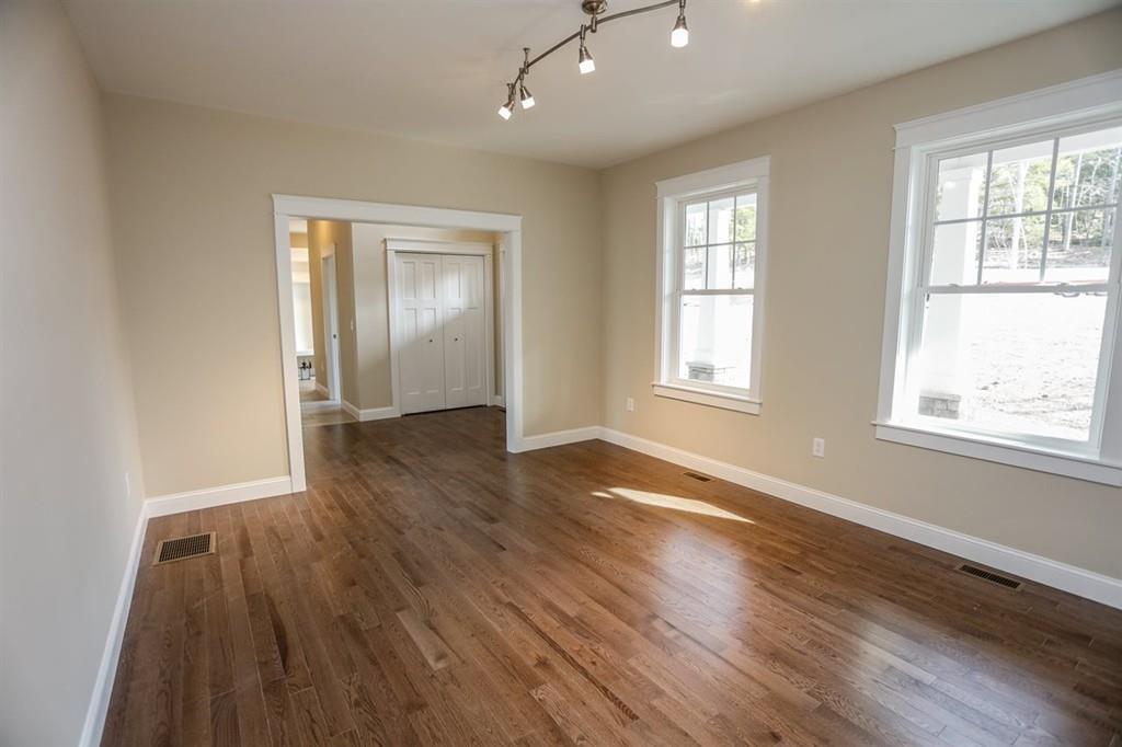 120 Pulpit Road Bedford, NH 03110 - Photo 35 of 40 an empty room with wooden floor and windows