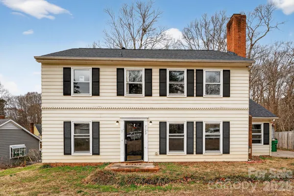 a view of a brick house with large windows